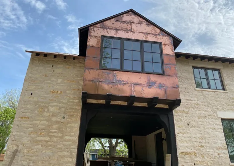 Copper metal panel facade on a stone building for Skylight Installation in Gastonia