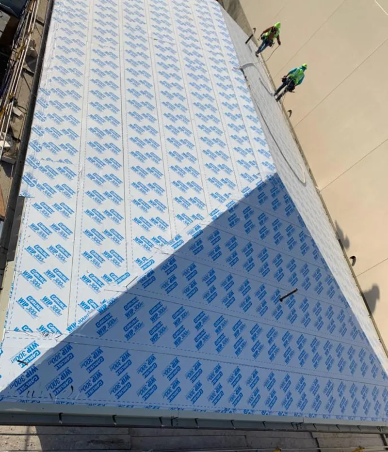 Professional roofers installing underlayment on a metal roof in Gastonia